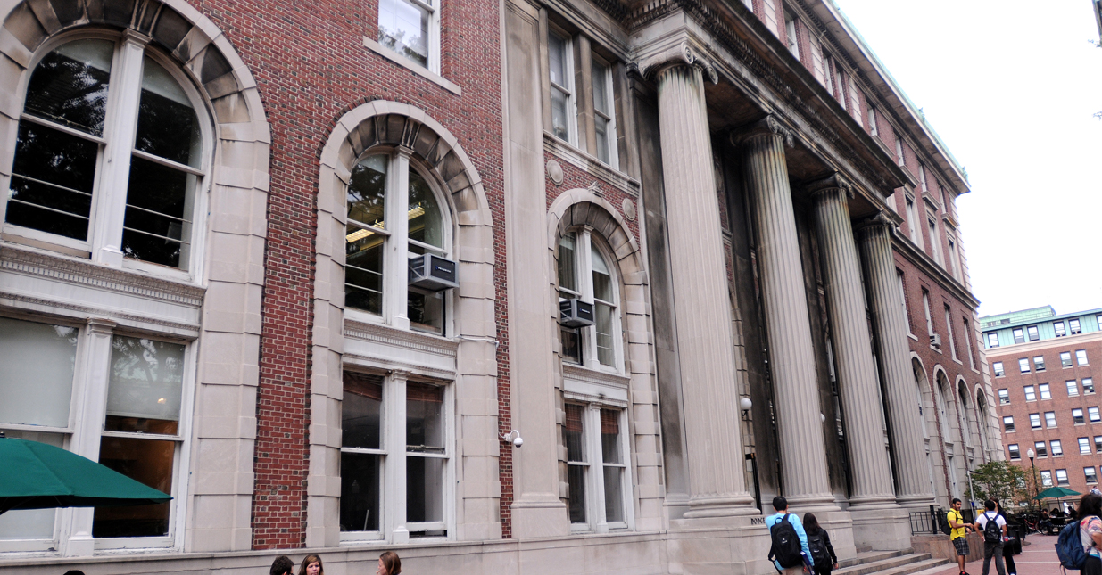 A side view of Dodge Hall with students walking in front of the entrance