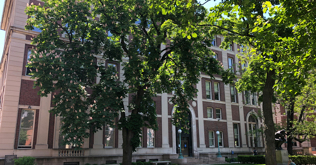 The exterior of Philosophy Hall on a sunny day with trees in front