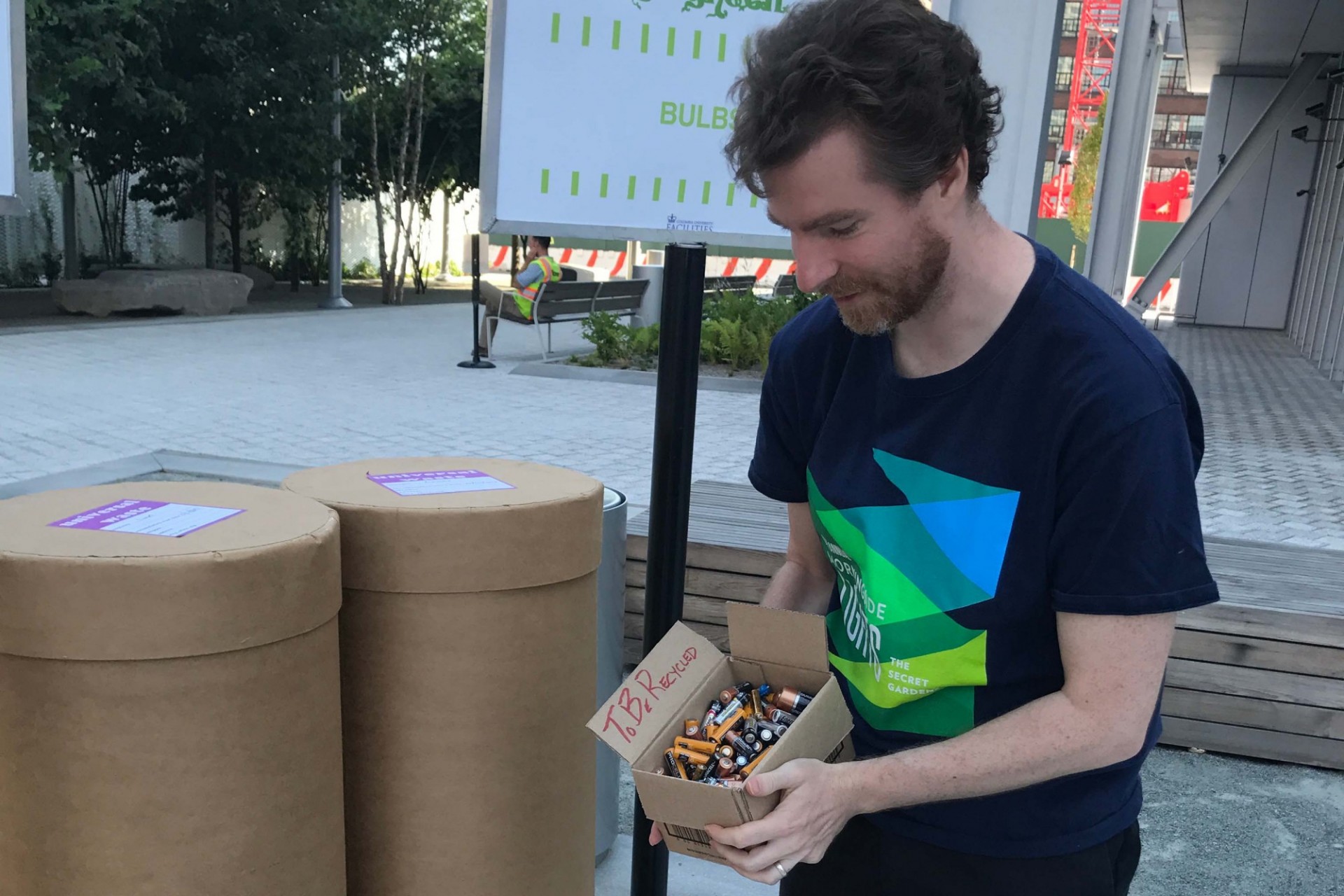 A person disposes of a box of batteries at one of the bins at Clean and Go Green.