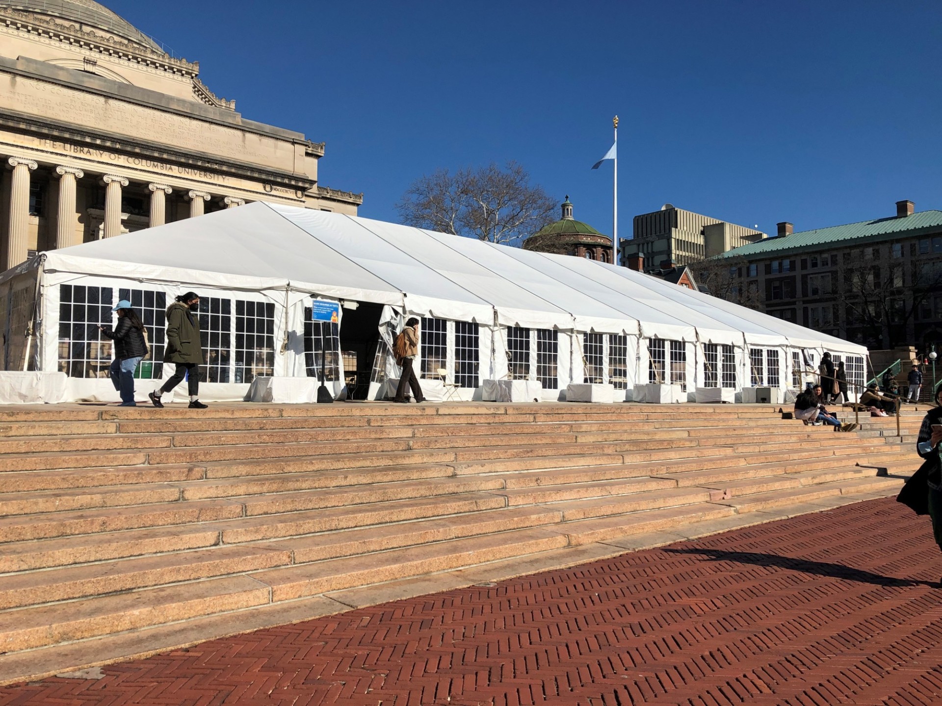 A white tent is erected across Low Plaza 