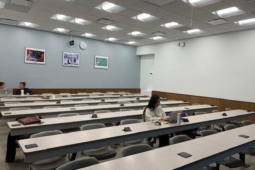 A freshly painted classroom in the International Affairs building that has contrasting Columbia blue and white walls.
