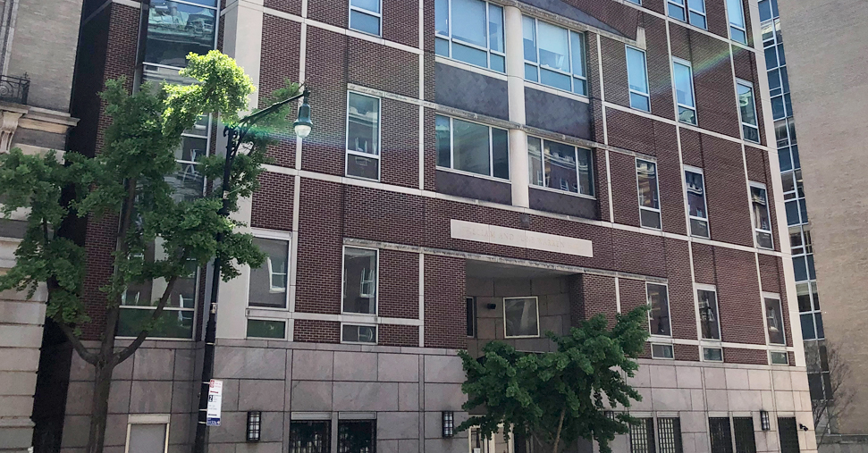 An exterior shot of William and June Warren Hall, a tall brick building 