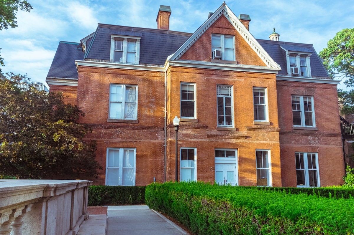 The exterior of Buell Hall, a brick building in front of a green lawn