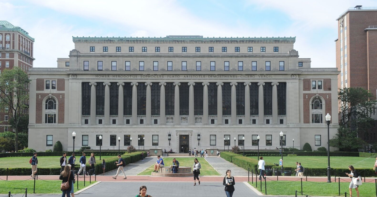 Butler Library in the day time from the perspective of Low Plaza with students walking in the forefront
