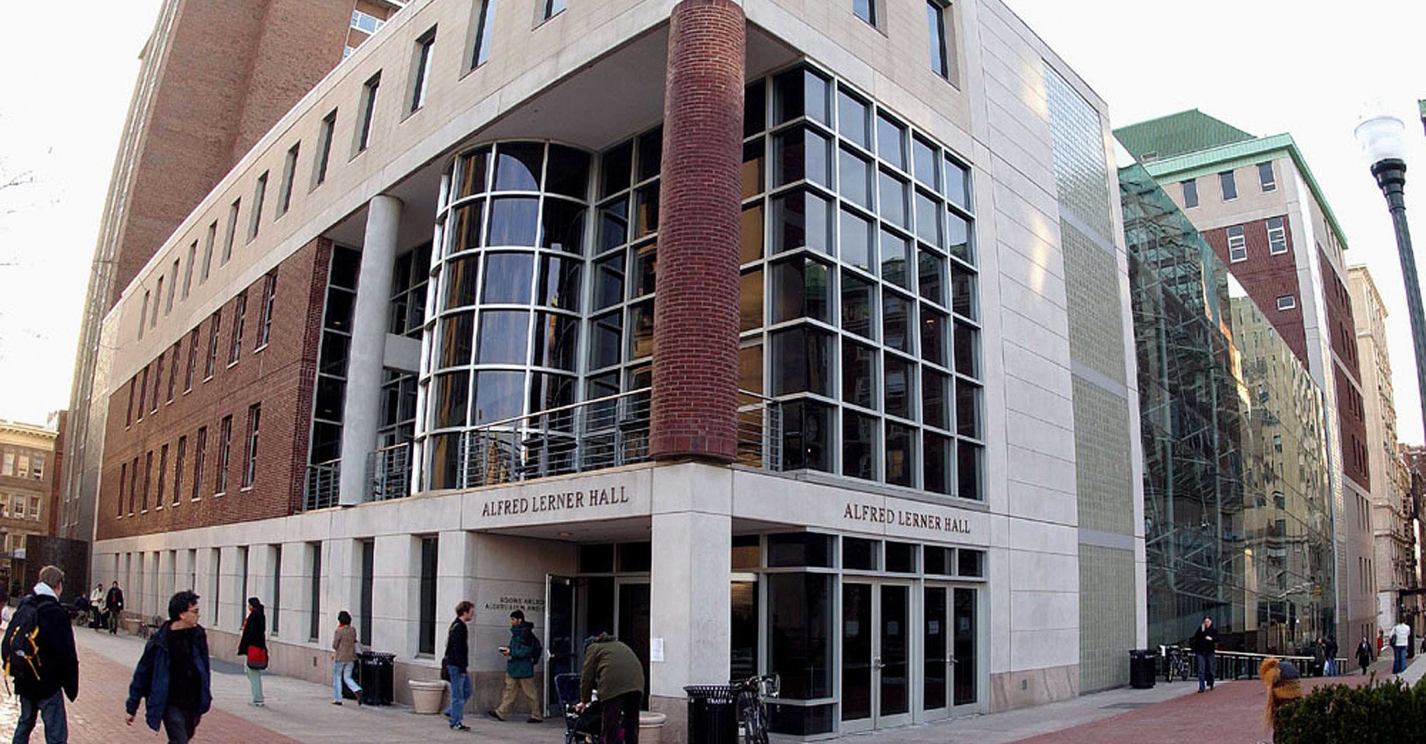 An exterior shot of the campus entrance of Lerner Hall with people walking by