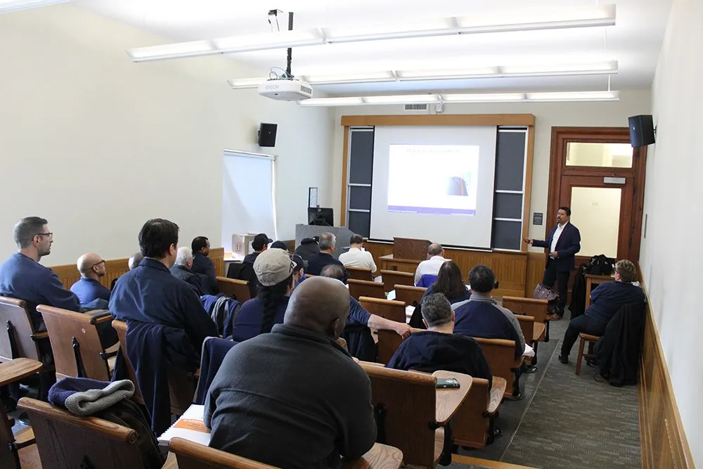 Columbia Residential supers sit in a lecture hall as an instructor presents on workplace safety measures.