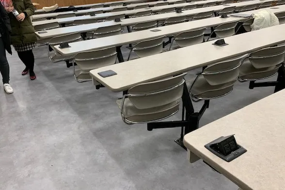 Gray flooring in IAB Room 413 with long rows of desks  