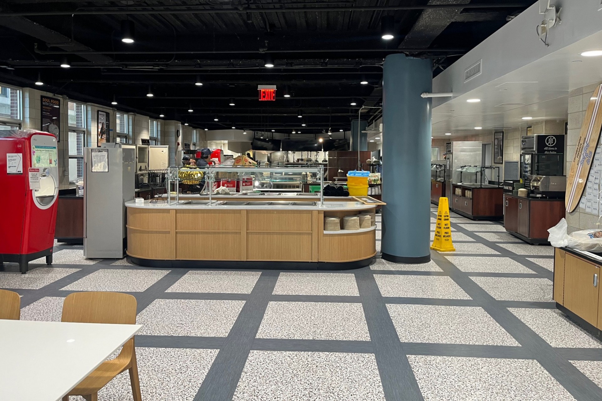 New square patterned flooring in Ferris Booth dining hall, that is light gray squares with dark speckles and is outlined by brushed steel grey.