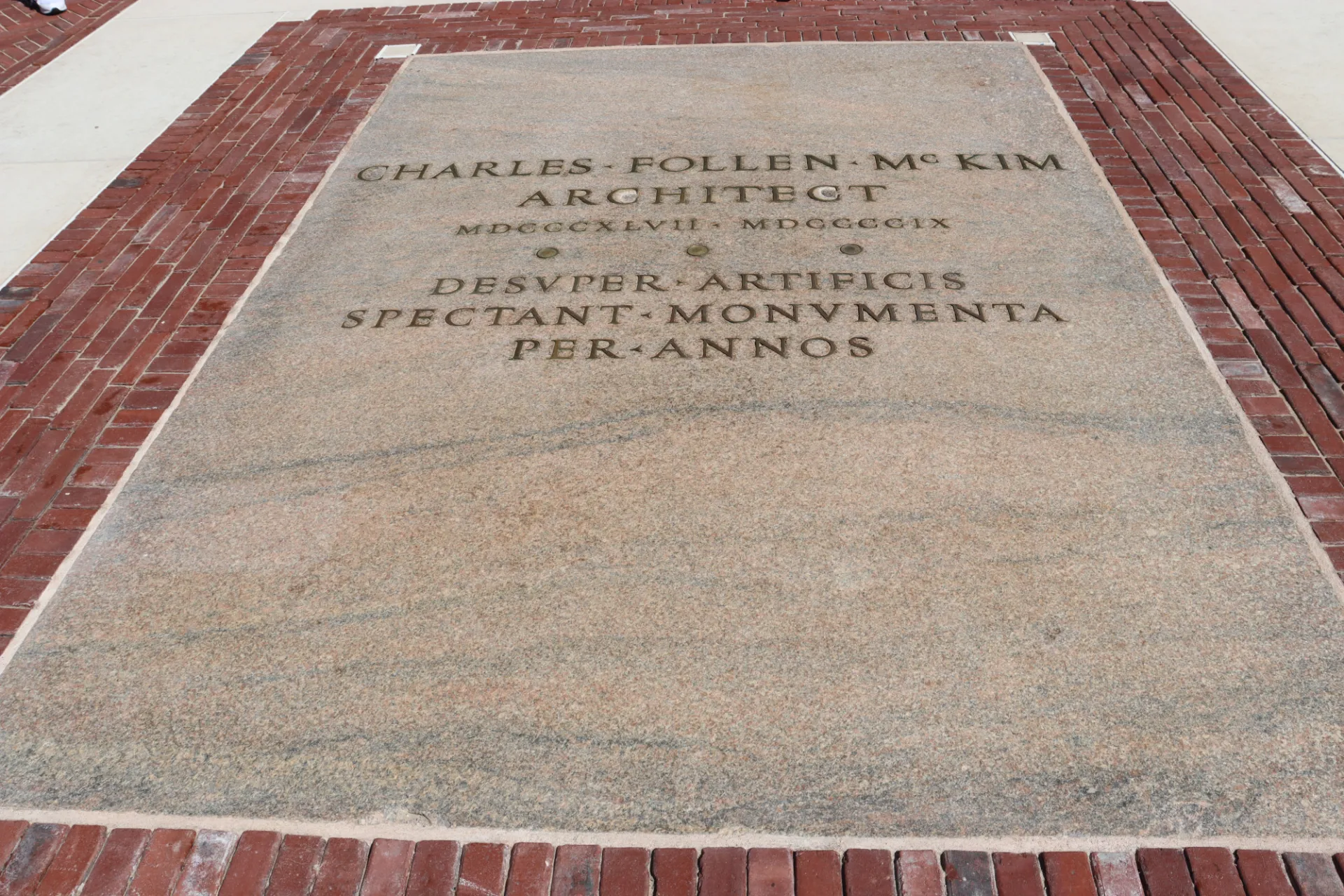 The plaque dedicated to Charles McKim cleaned and restored, with brick from Low Plaza's original construction around it.