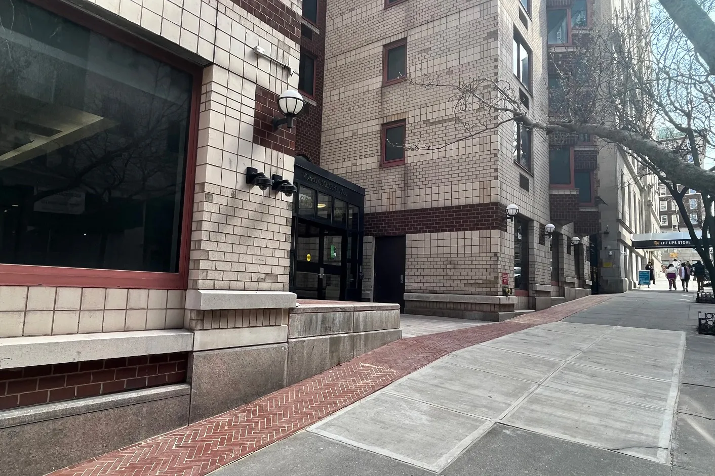 The building entrance to Schapiro Hall, featuring new brick and stone pavers at the entrance pathway.