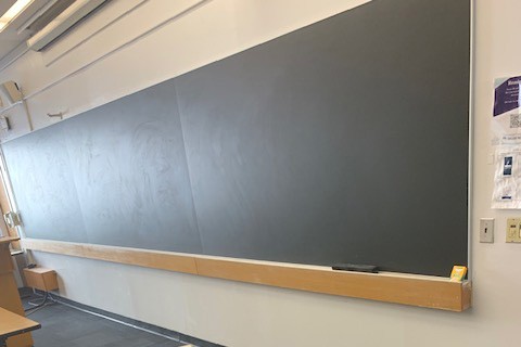 A new chalkboard was installed in Uris 331 to replace a cracked and pitted chalkboard. A new chalkboard installed inside a classroom.
